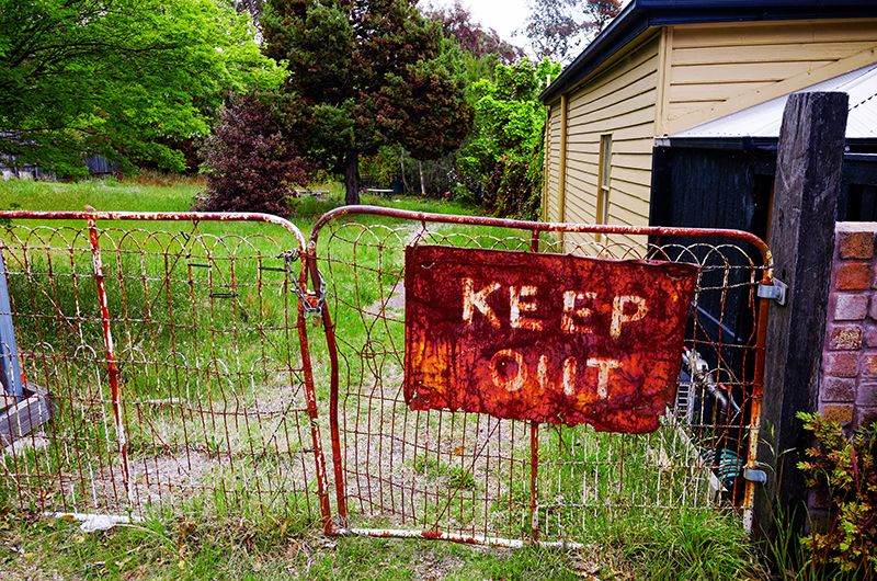 old gate with Keep out message