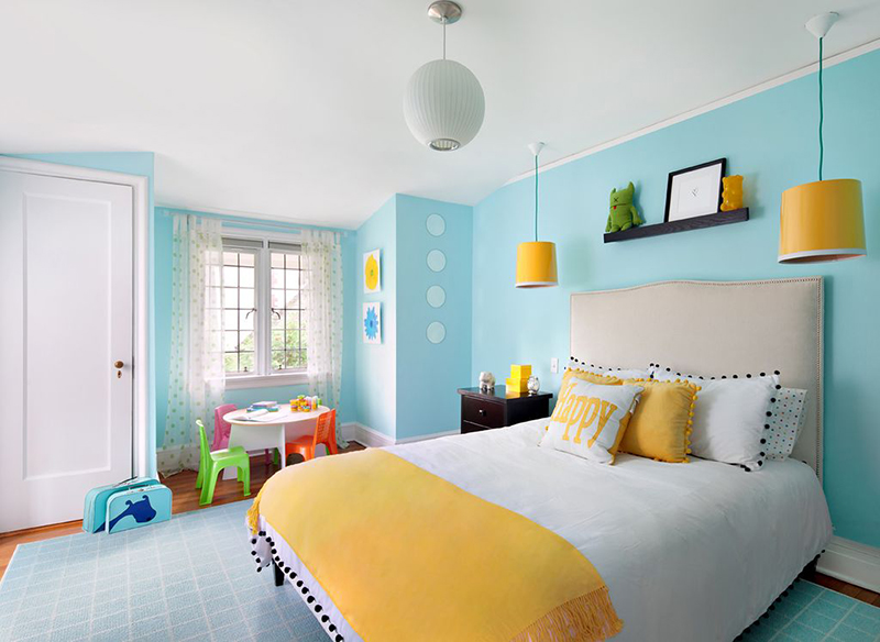 Remodeled bedroom with pendant lights and bright colors.