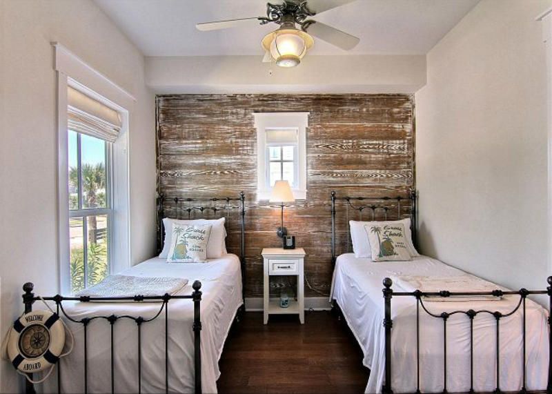 Farmhouse-style bedroom with distressed wood accent wall.