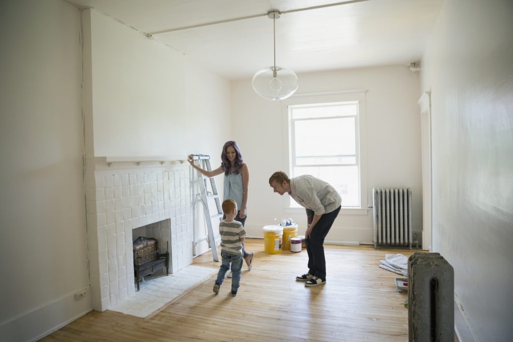 Photo of parents with child in a room being remodeled