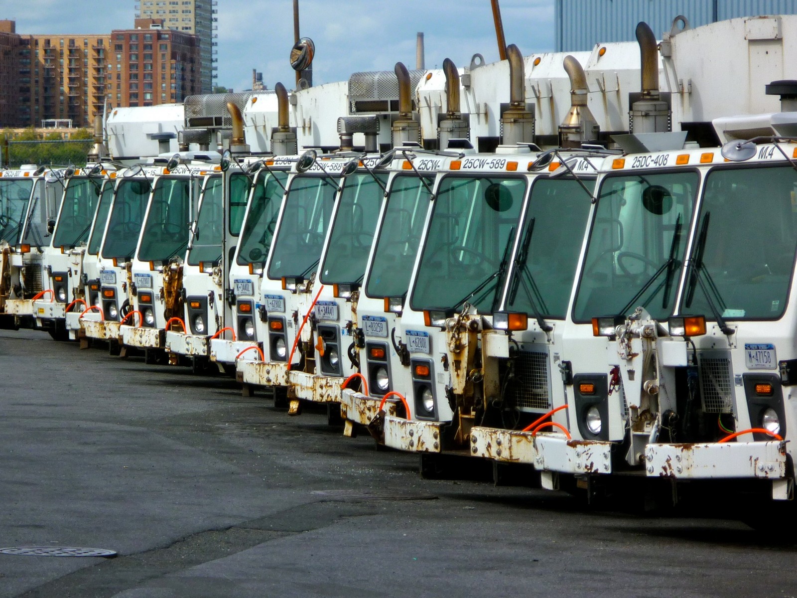 image of garbage trucks