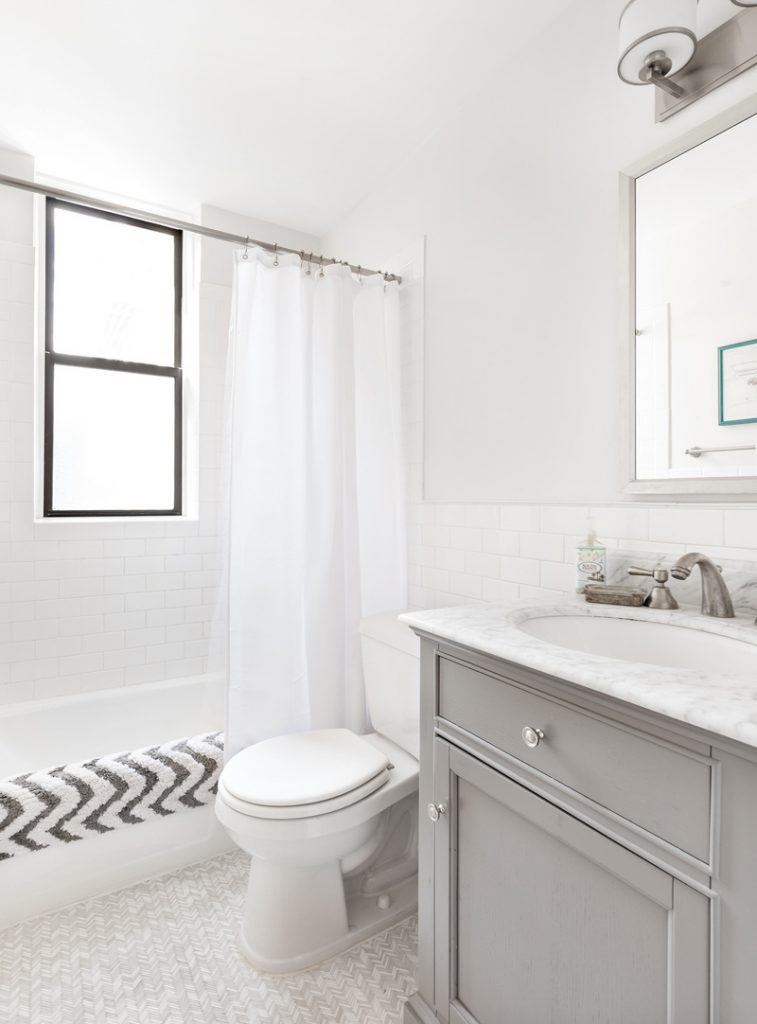 The bathroom is newly renovated, with a marble-top vanity and high-end details.